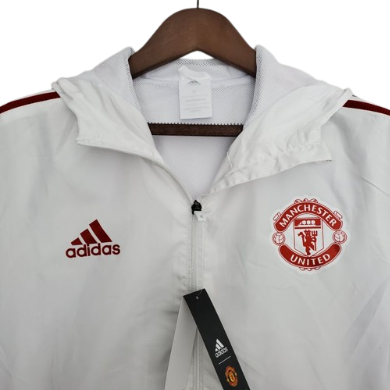 JAQUETA CORTA VENTO MANCHESTER UNITED BRANCO/VERMELHO - 2021/22